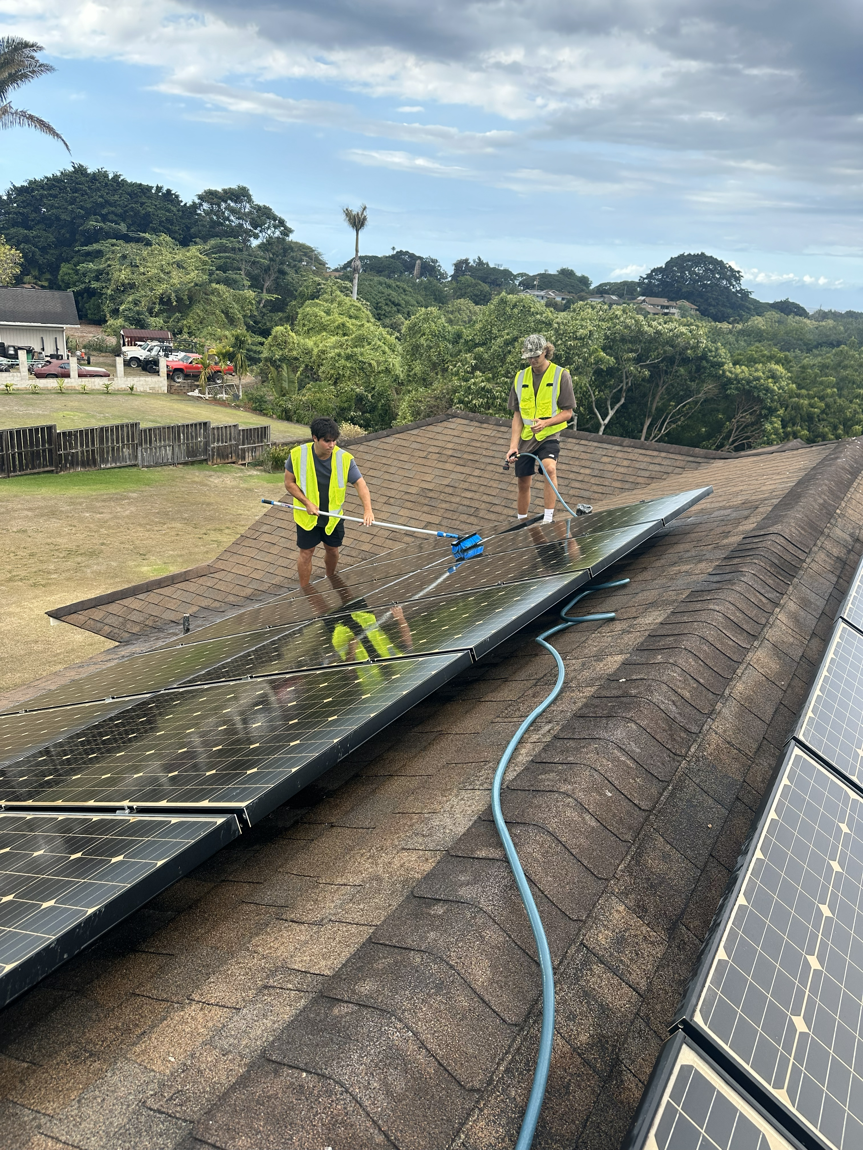 North Shore Solar Cleaning crew working on roof in Haleiwa